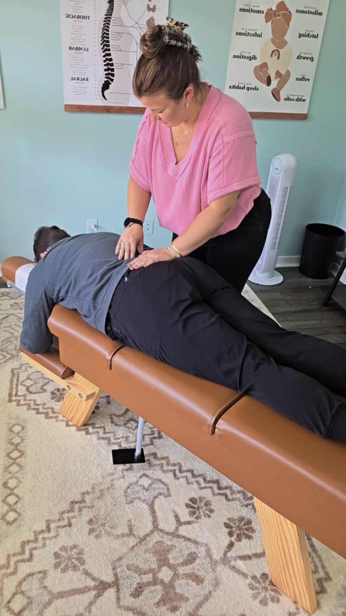 Dr. Kayla adjusting an adult patient